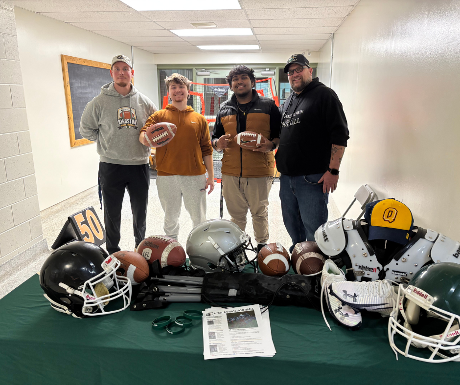 Students Standing with Football Equipment