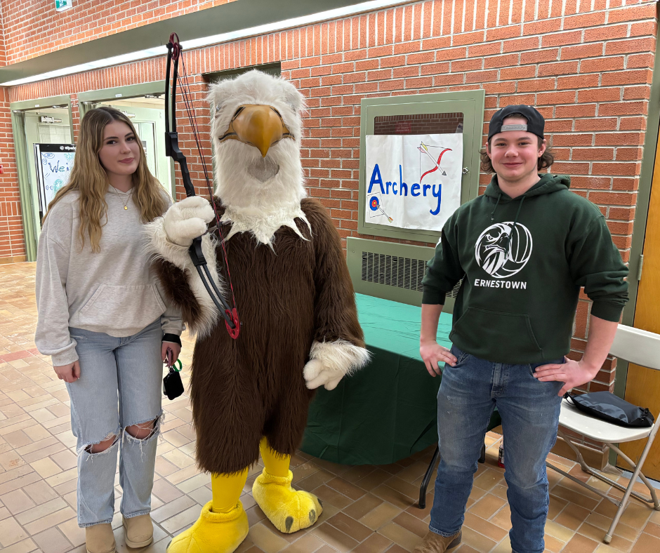 Students standing with ESS mascot