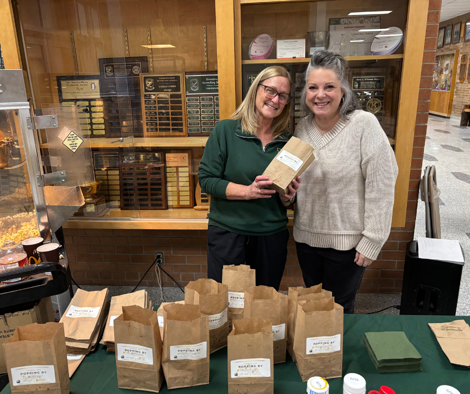 ESS staff members standing behind a table with popcorn